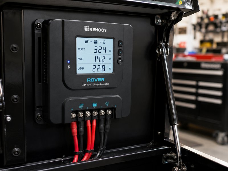 Renogy Rover MPPT charge controller mounted inside rolling toolbox showing watts, voltage, and amps on LCD