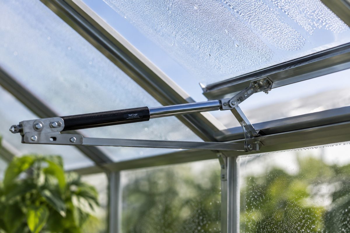 Wax-cylinder automatic vent opener attached to a hinged greenhouse roof panel